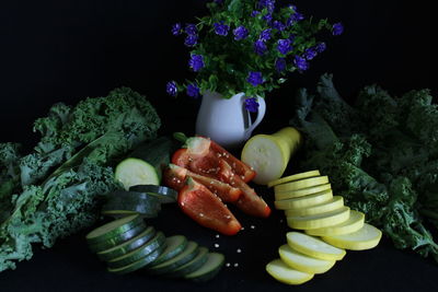Close-up of chopped vegetables on table against black background