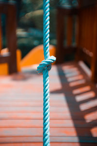 Close-up of rope tied on wood