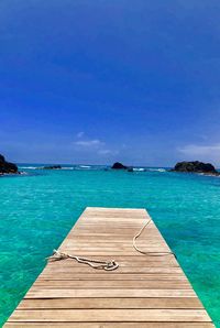 Scenic view of sea and pier against sky