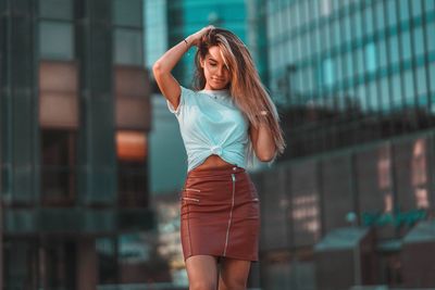 Young woman standing against blurred background