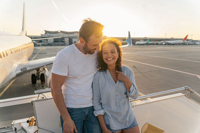 Portrait of smiling couple standing against sky