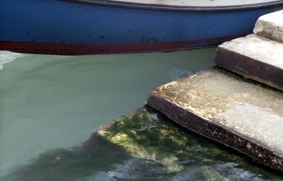 Close-up of boat moored on lake