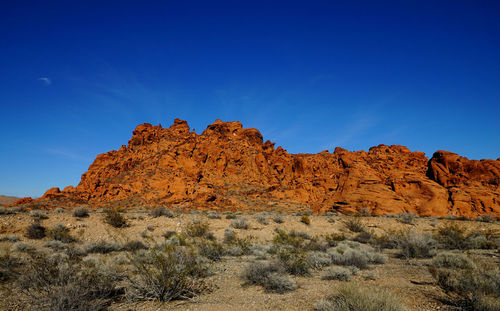 Scenic view of rocky mountains against clear blue sky