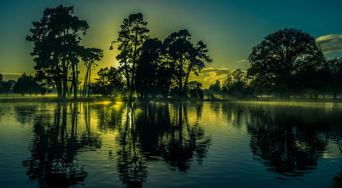 Scenic view of lake at sunset