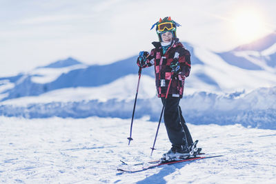 Portrait of boy skiing on snowcapped mountain
