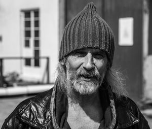 Portrait of senior man wearing knit hat at city