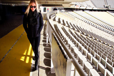 Portrait of beautiful woman walking at empty stadium