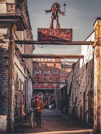 People walking by building in city