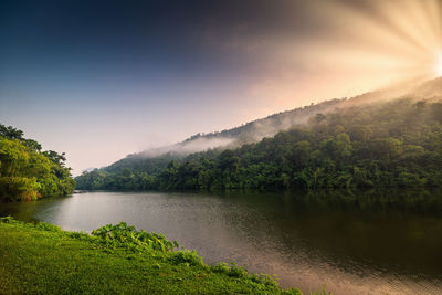 Scenic view of lake and mountains against sky