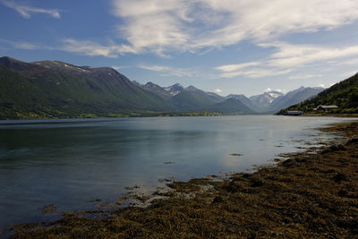 Scenic view of lake and mountains against sky