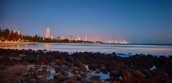 Scenic view of sea against clear sky during sunset