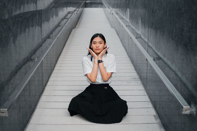 Portrait of a young woman sitting outdoors