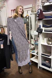 Woman checking dress in shop