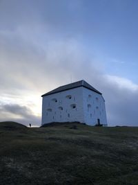 Low angle view of building on field against sky