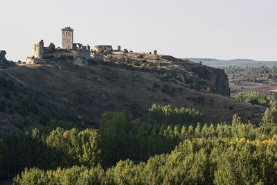 View of castle on mountain against clear sky