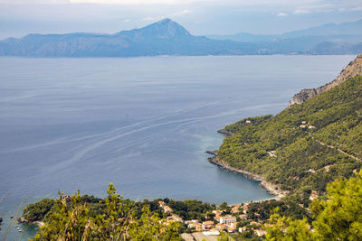 High angle view of sea and townscape against sky