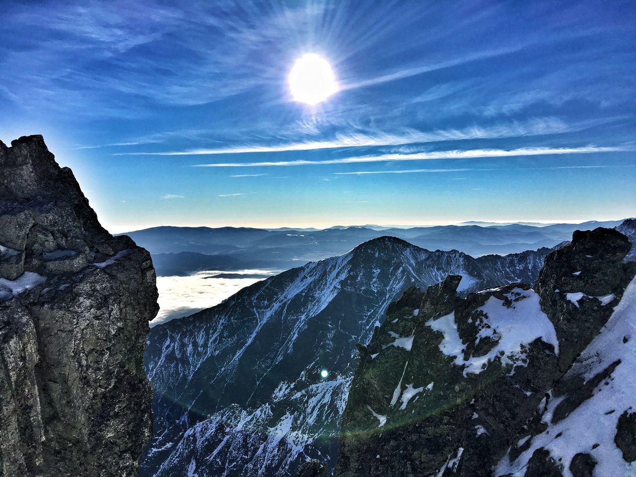 mountain, snow, sun, tranquil scene, tranquility, winter, cold temperature, scenics, beauty in nature, mountain range, sunlight, sunbeam, nature, landscape, sky, lens flare, season, blue, idyllic, non-urban scene