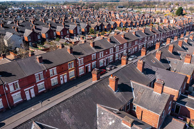 An aerial view above the rooftops of run down terraced houses in the north of england