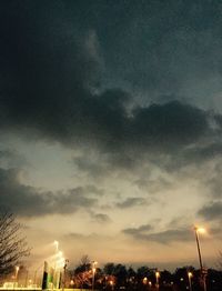 Low angle view of illuminated street light against sky at night