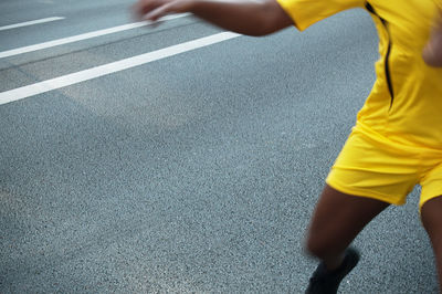 Low section of man running on road