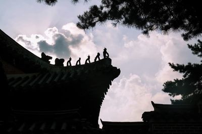 Low angle view of building against cloudy sky