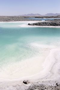 Scenic view of salt lake against sky