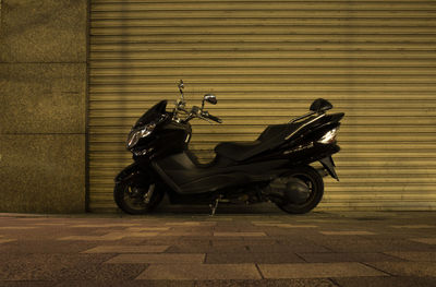 Side view of motor scooter parked on street