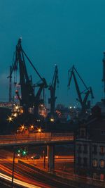 Illuminated commercial dock against sky at night