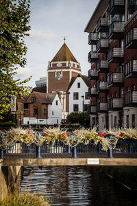 Canal amidst buildings against sky