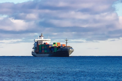 Ship sailing on sea against sky