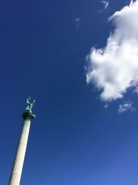 Low angle view of statue against blue sky