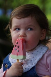 Close-up of innocent girl eating flavored ice