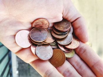 Close-up of hand holding coins