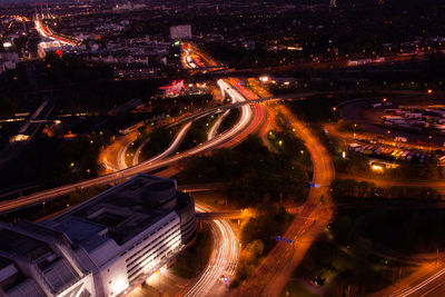 Aerial view of illuminated elevated roads in city at night