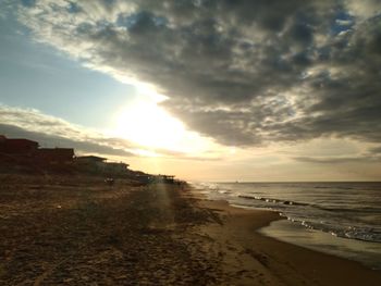 Scenic view of beach against sky during sunset