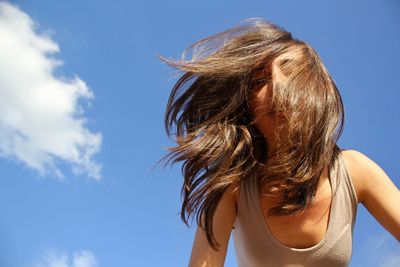 Low angle view of woman against sky