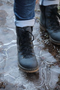 Low section of man standing on land