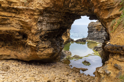 Rocks in sea seen through cave