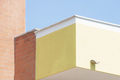 Low angle view of building against clear blue sky