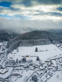 Snow covered landscape against sky