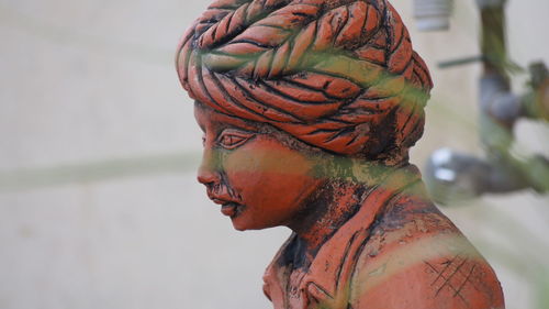 Close-up portrait of a statue against blurred background