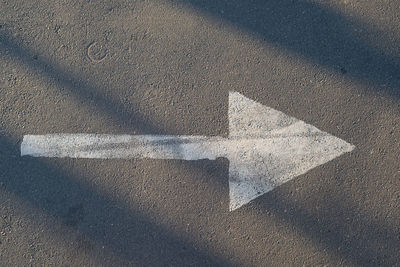 High angle view of arrow symbol on road