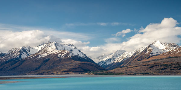 Mount cook road alongside lake pukaki with snow capped southern alps in winter evening light. 