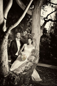 Young couple sitting on tree trunk