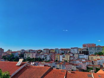 High angle view of townscape against blue sky