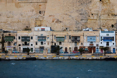 Buildings by sea in city