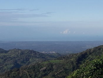 Scenic view of sea and mountains against sky