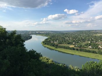 Scenic view of river by landscape against sky