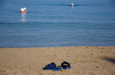 Flip-flop on sand at beach