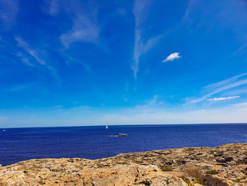 Scenic view of sea against blue sky